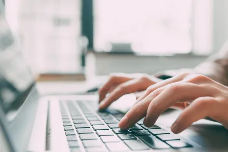 Person typing on a computer